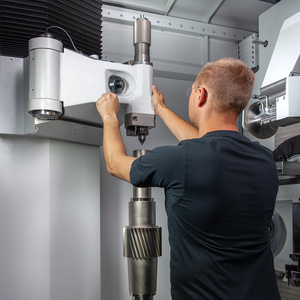 An employee operates the tailstock.